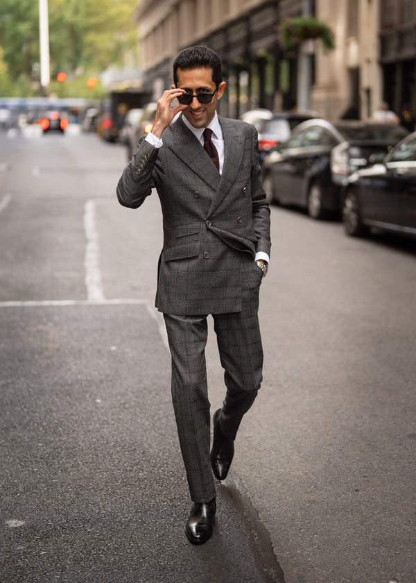 Man in a gray suit walking on a city street