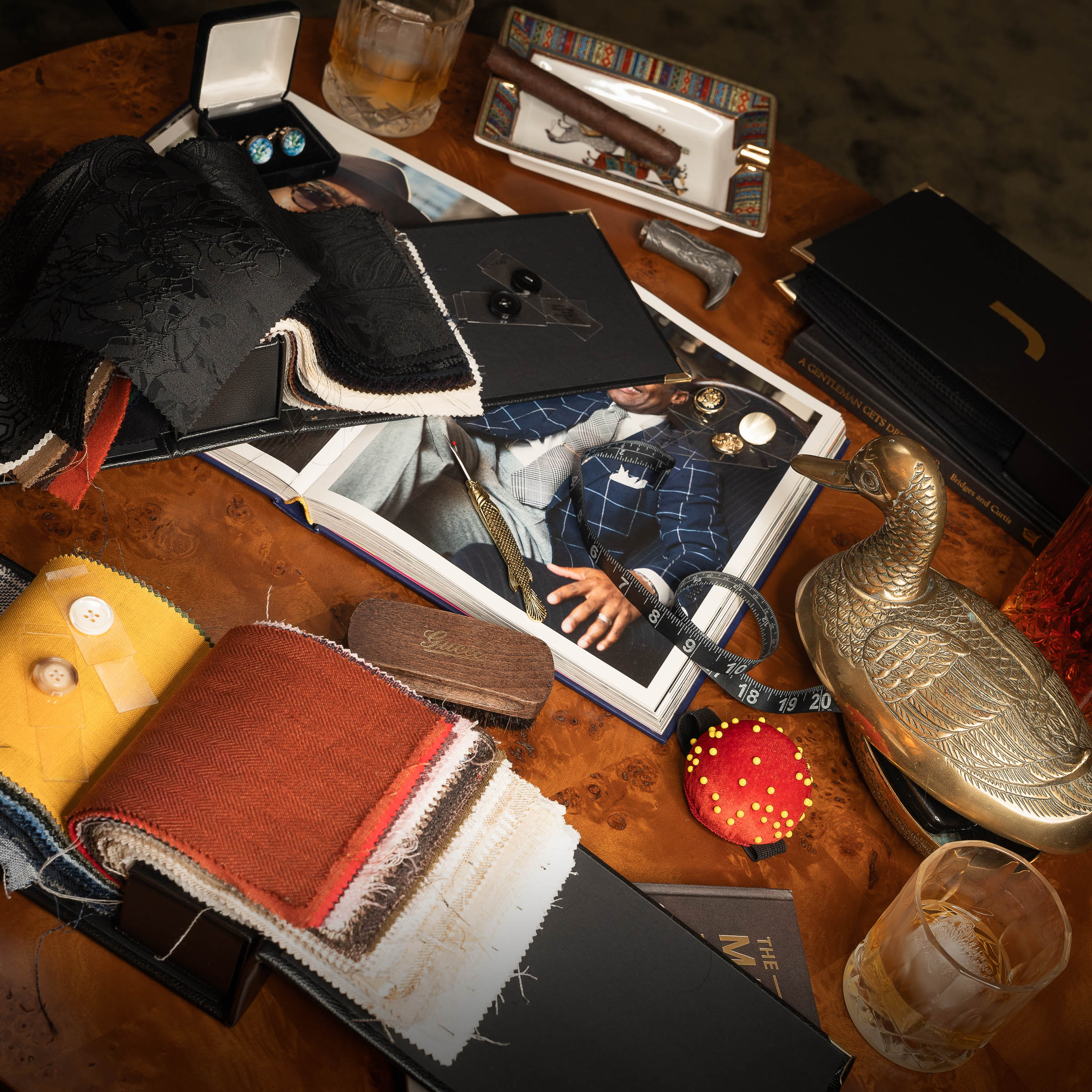 Collection of men's accessories on a wooden table.