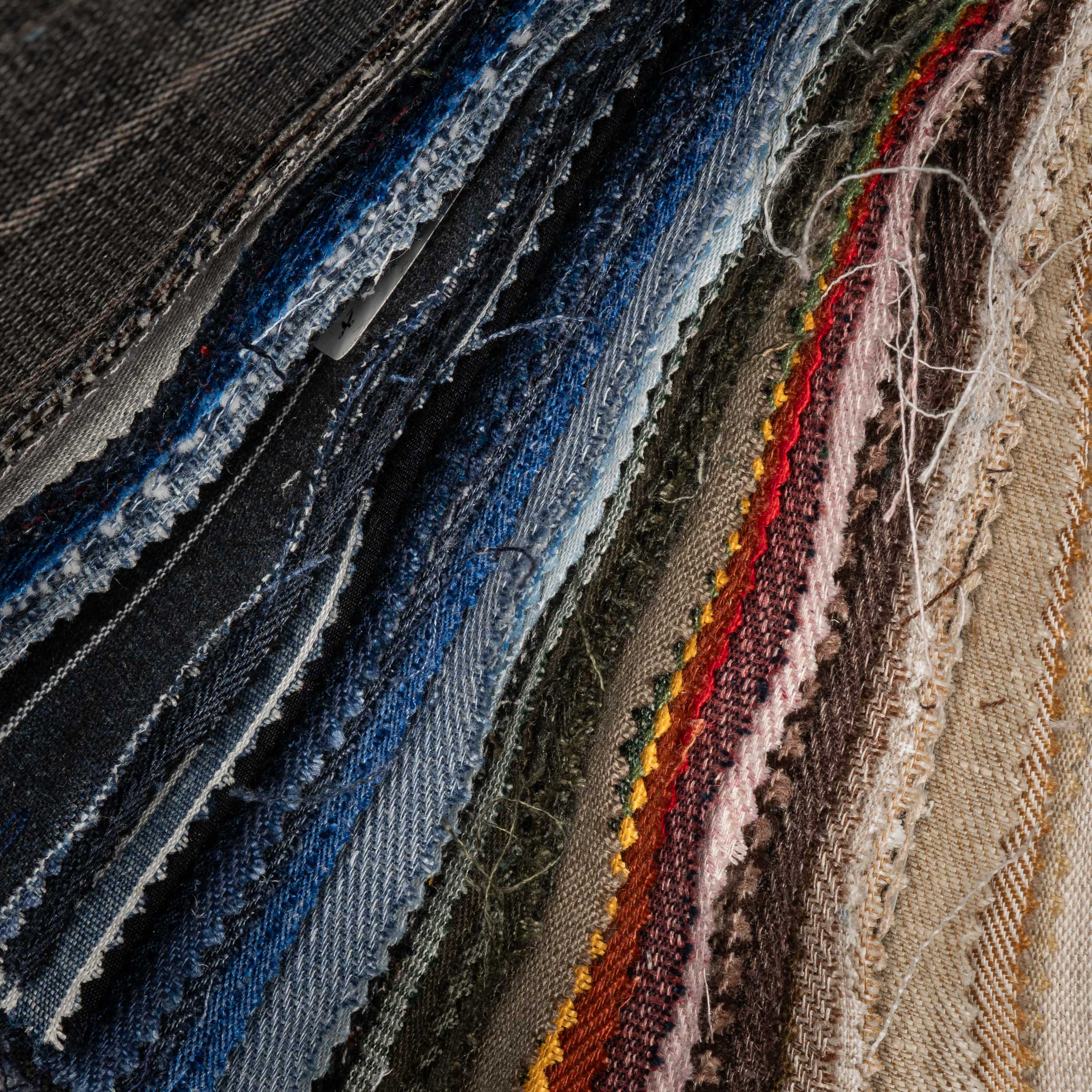 Close-up of various textured fabric samples in different colors.